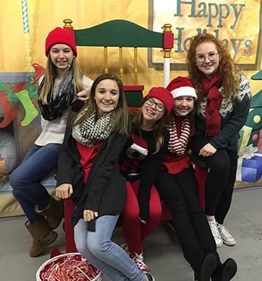 photo of five girls in huge rocking chair 
